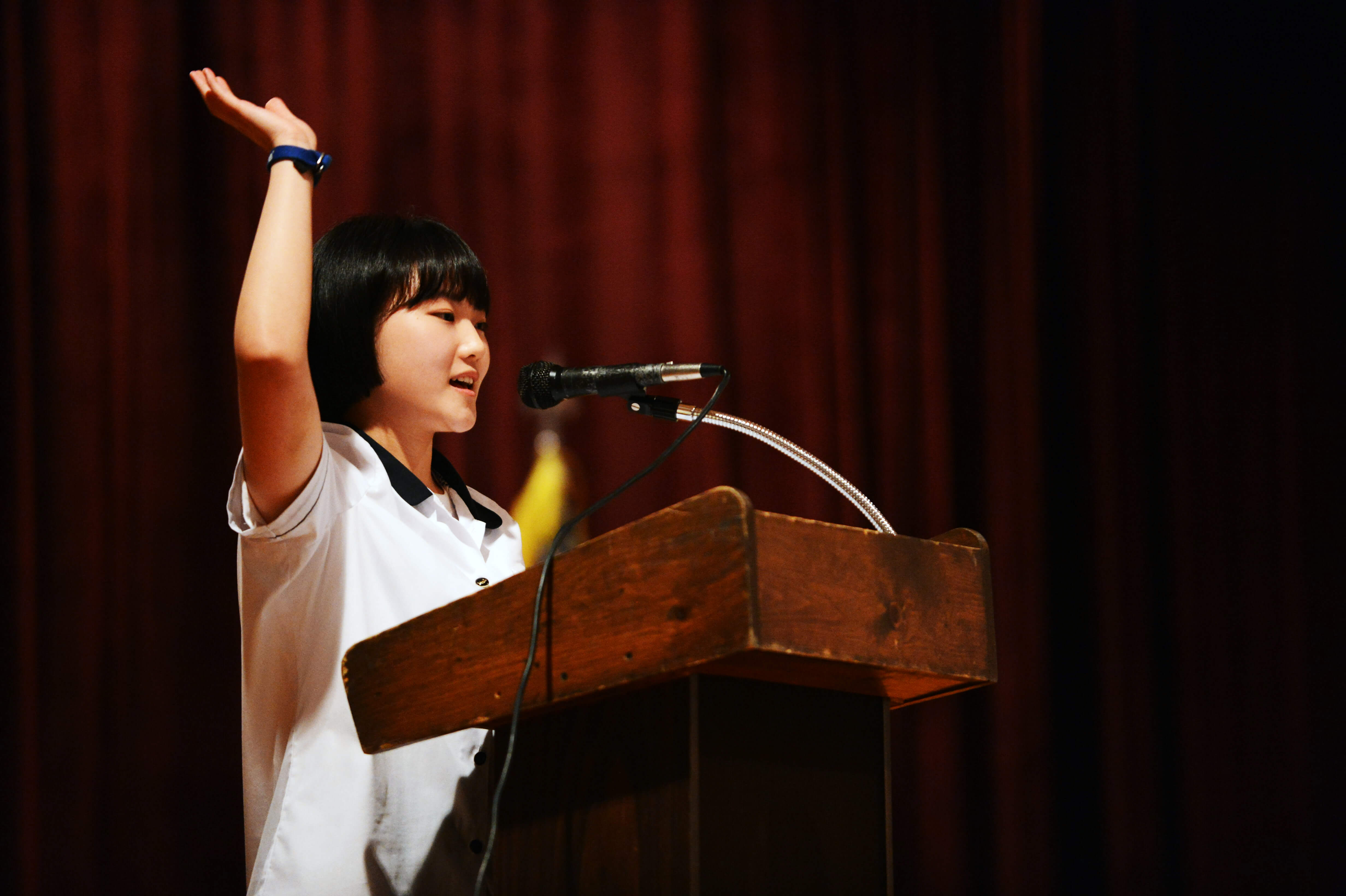 A girl standing at a podium giving a speech