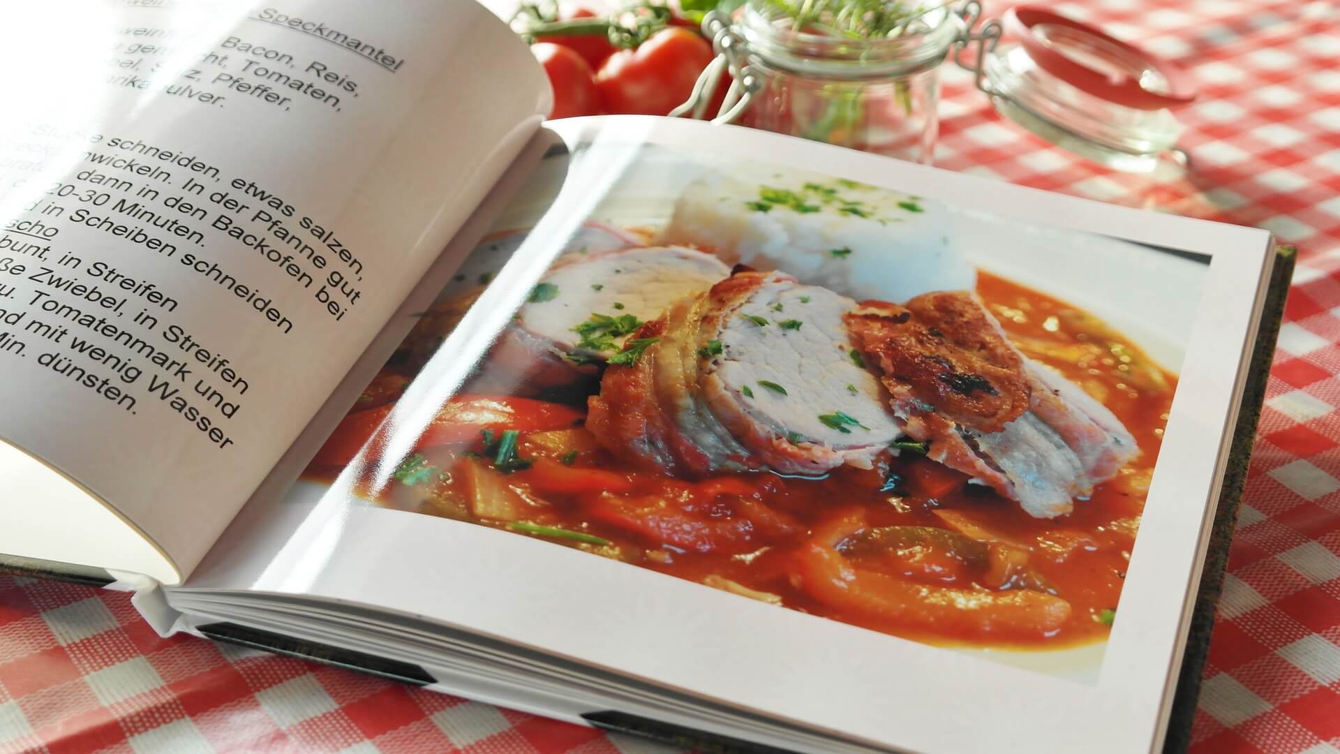 A cookbook, laying on a table, open to a particular recipe