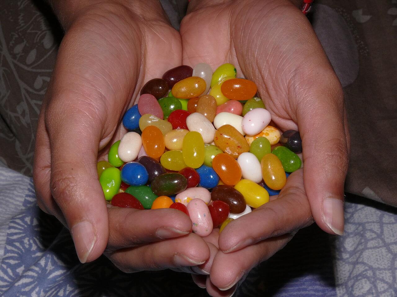 A bunch of jelly beans in two hands.