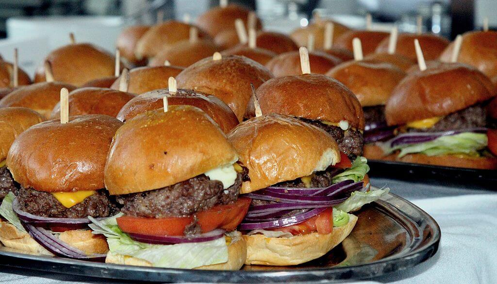 A selection of sliders, served on a party tray.