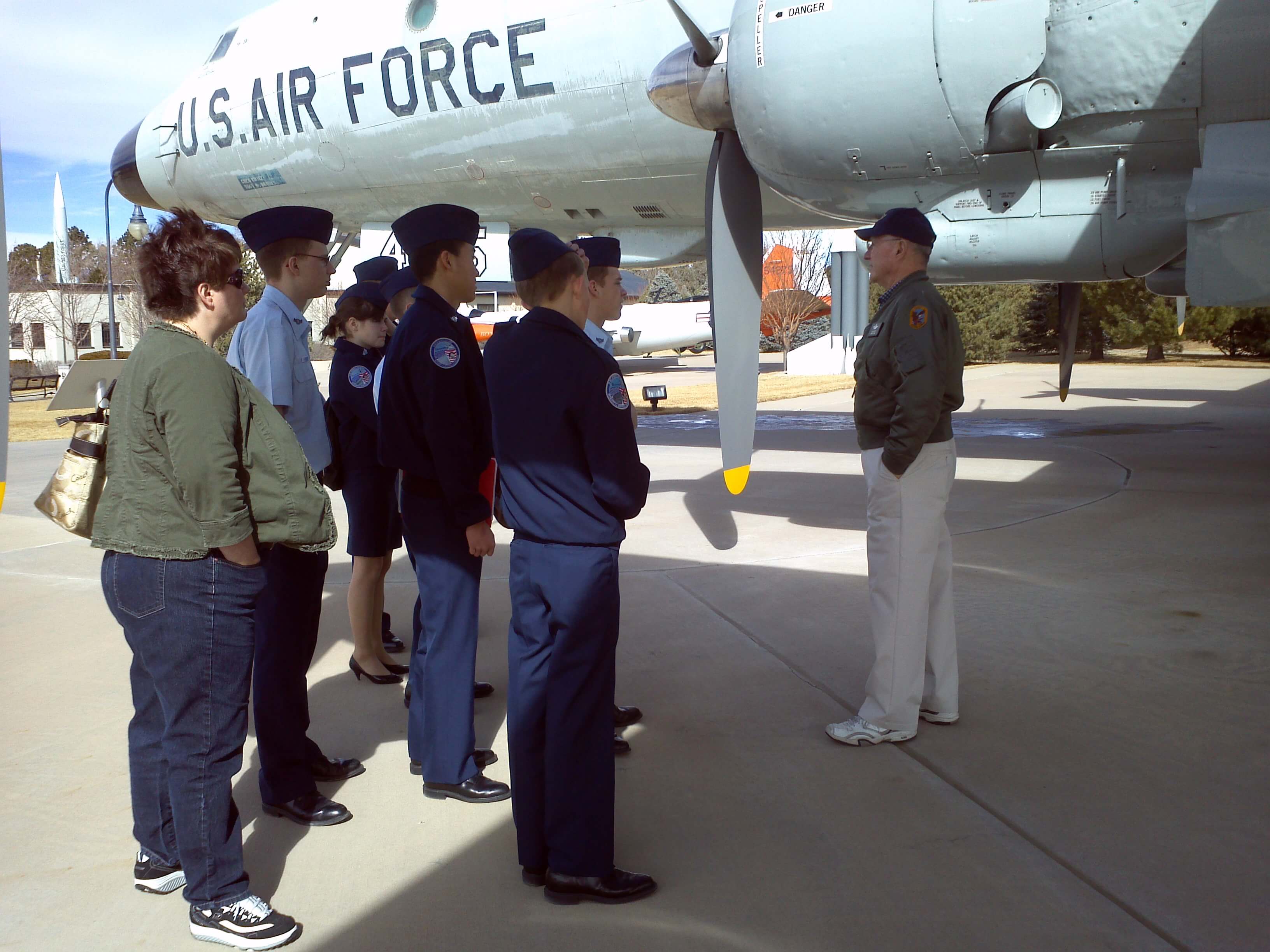 A tour guide leads high-school cadets on a tour of Peterson Air Force Base