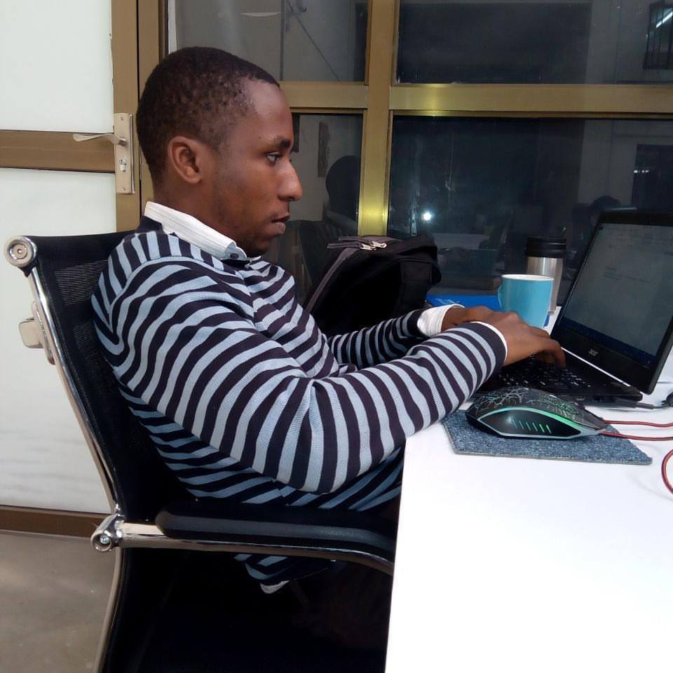 A Kenyan programmer sits at his computer.