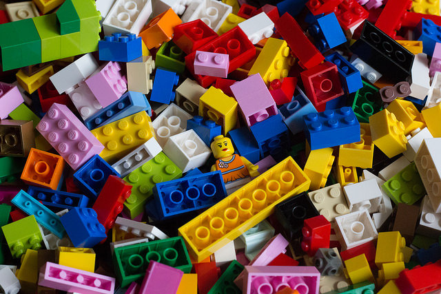 A LEGO minifigure half-buried in LEGO pieces